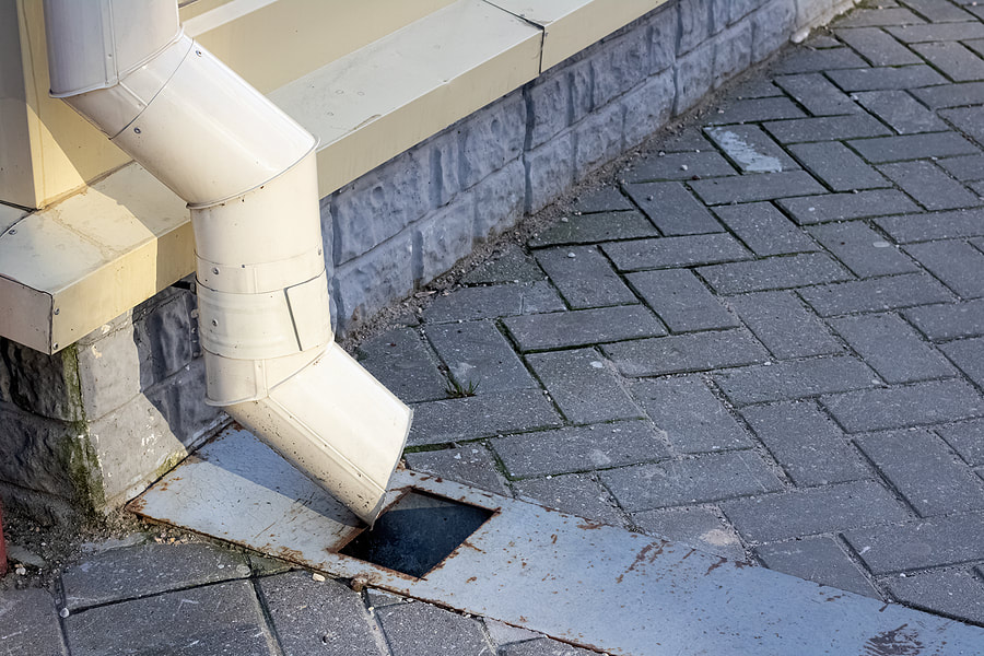a white pipe pointing to drain